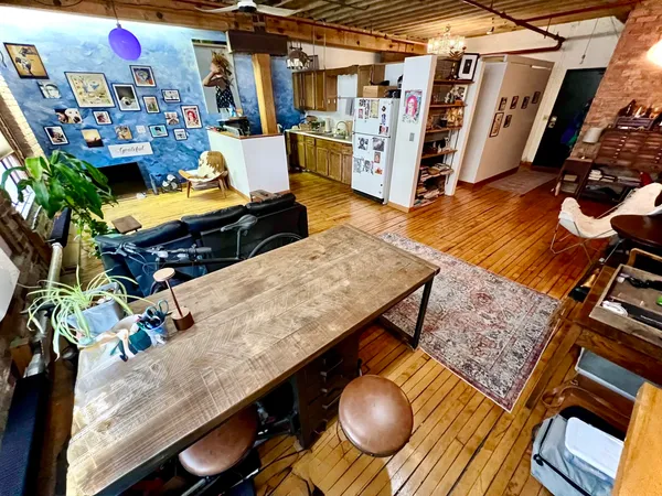 a view of a room with wooden floor