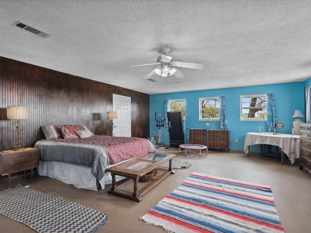 265 County Road 4374 Decatur, TX 76234 - Photo 18 of 32 a bedroom with furniture and a chandelier