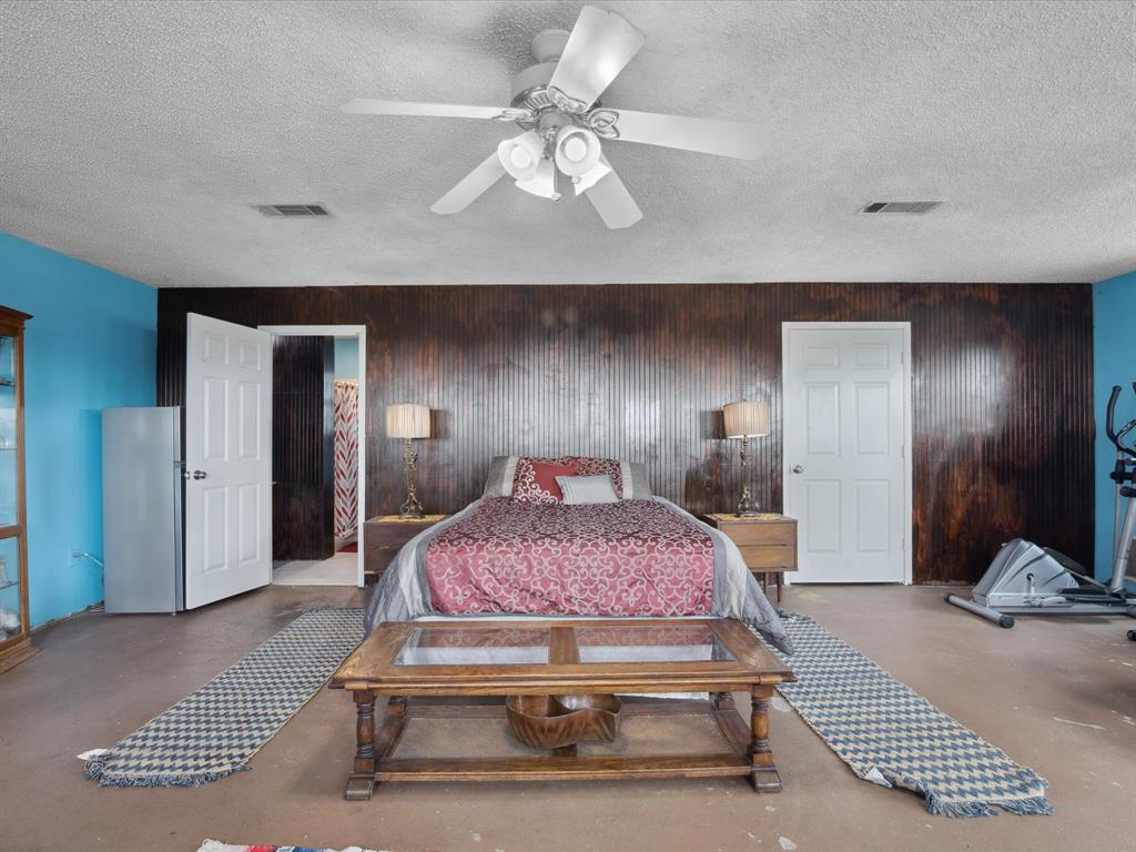 265 County Road 4374 Decatur, TX 76234 - Photo 19 of 32 a bedroom with a bed and a mirror