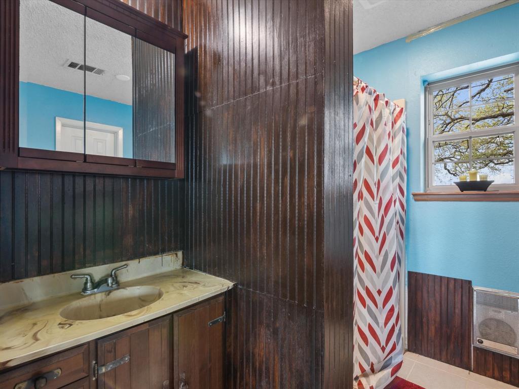 265 County Road 4374 Decatur, TX 76234 - Photo 22 of 32 a bathroom with a sink and a mirror