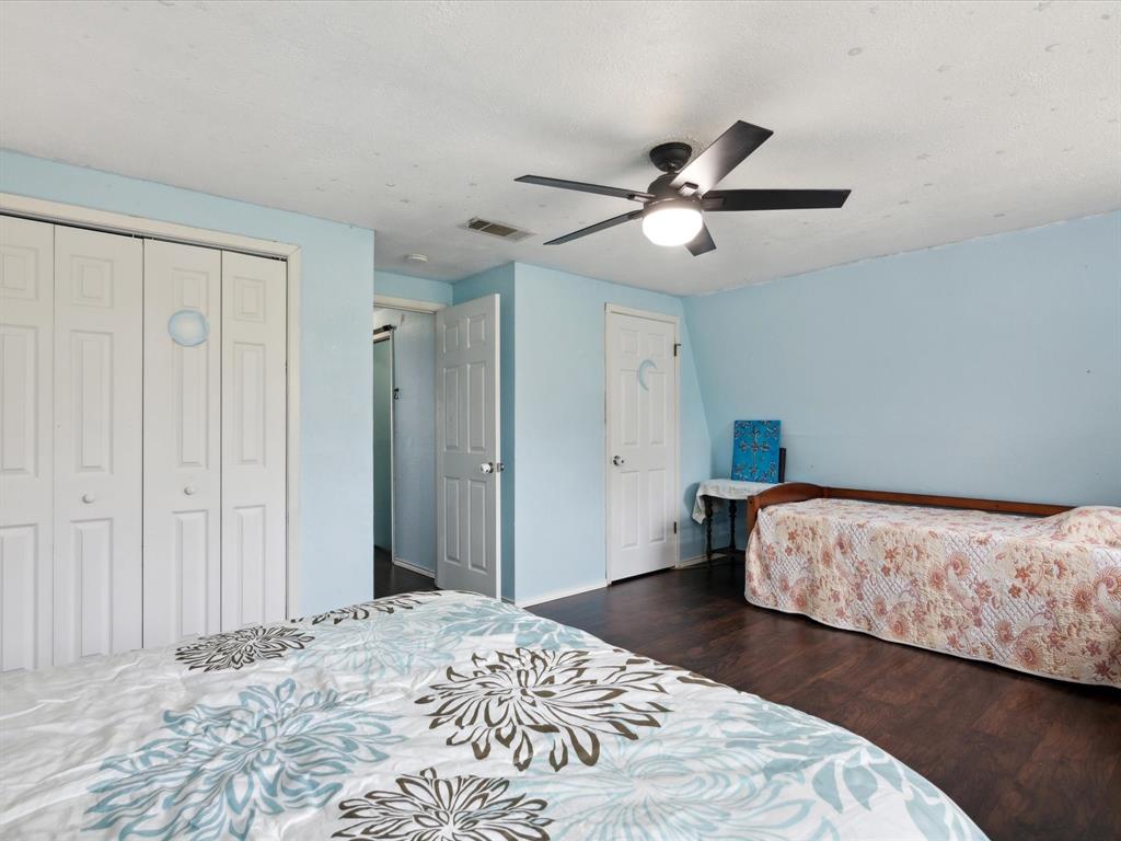 265 County Road 4374 Decatur, TX 76234 - Photo 25 of 32 a bedroom with a bed and a chandelier