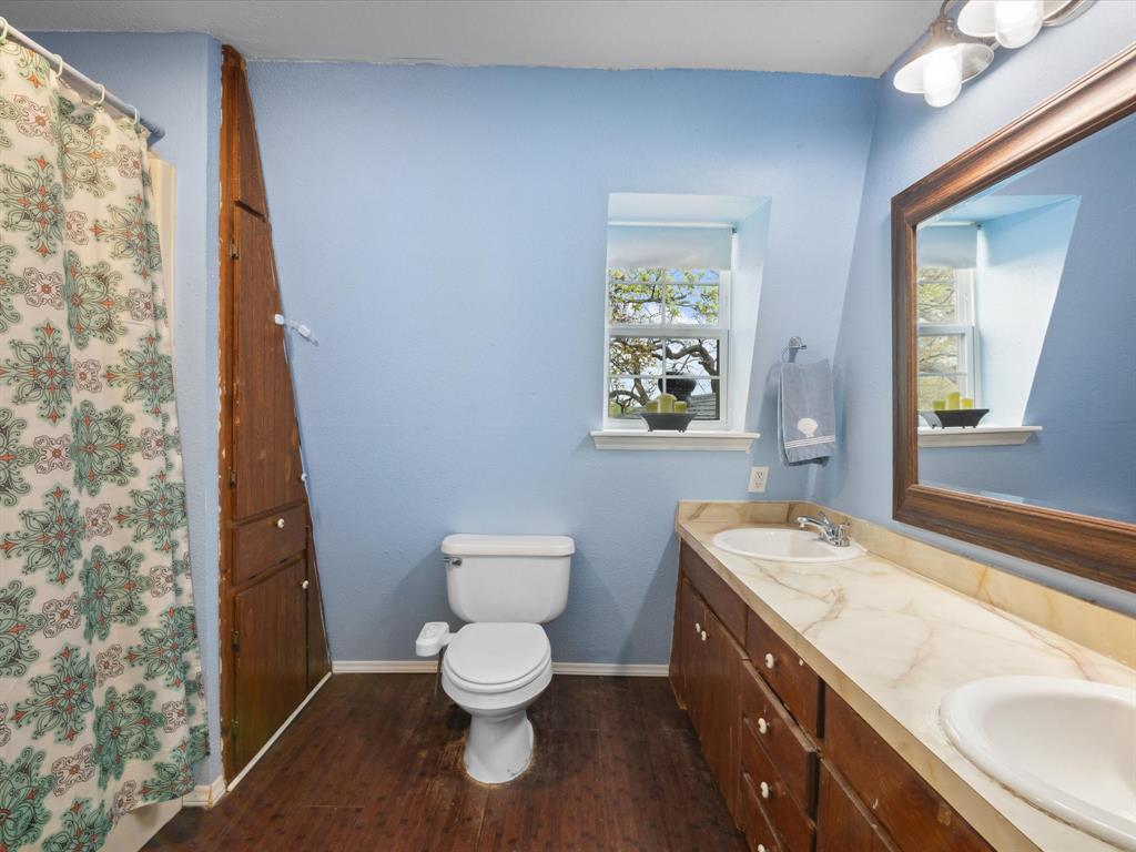 265 County Road 4374 Decatur, TX 76234 - Photo 26 of 32 a spacious bathroom with a toilet sink and mirror