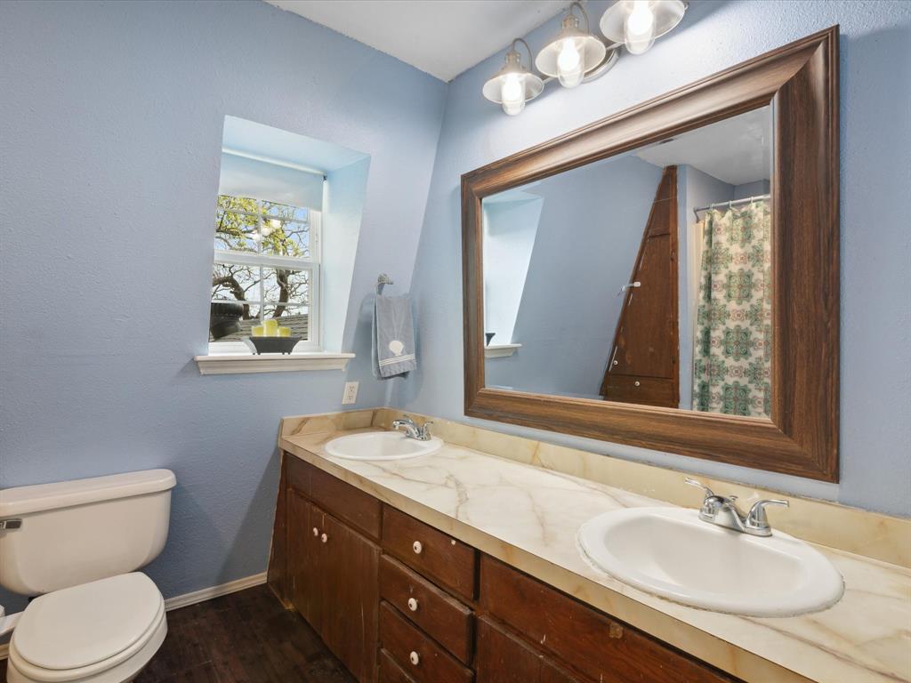 265 County Road 4374 Decatur, TX 76234 - Photo 27 of 32 a bathroom with a granite countertop sink vanity mirror and toilet