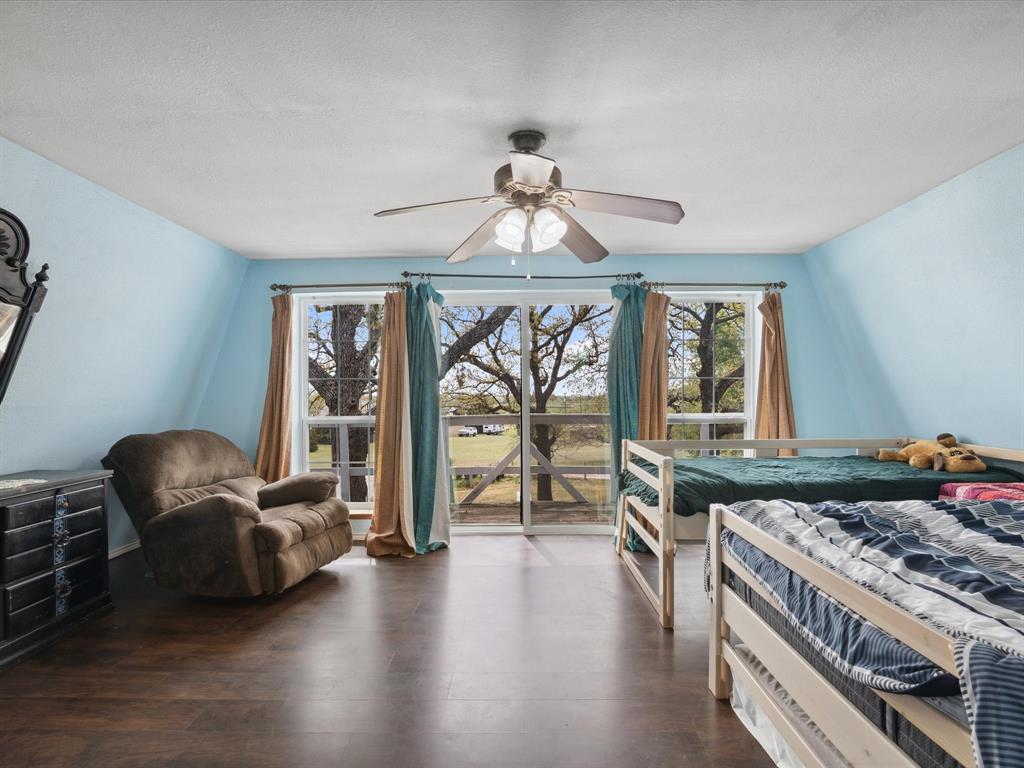 265 County Road 4374 Decatur, TX 76234 - Photo 28 of 32 a living room with furniture and a floor to ceiling window