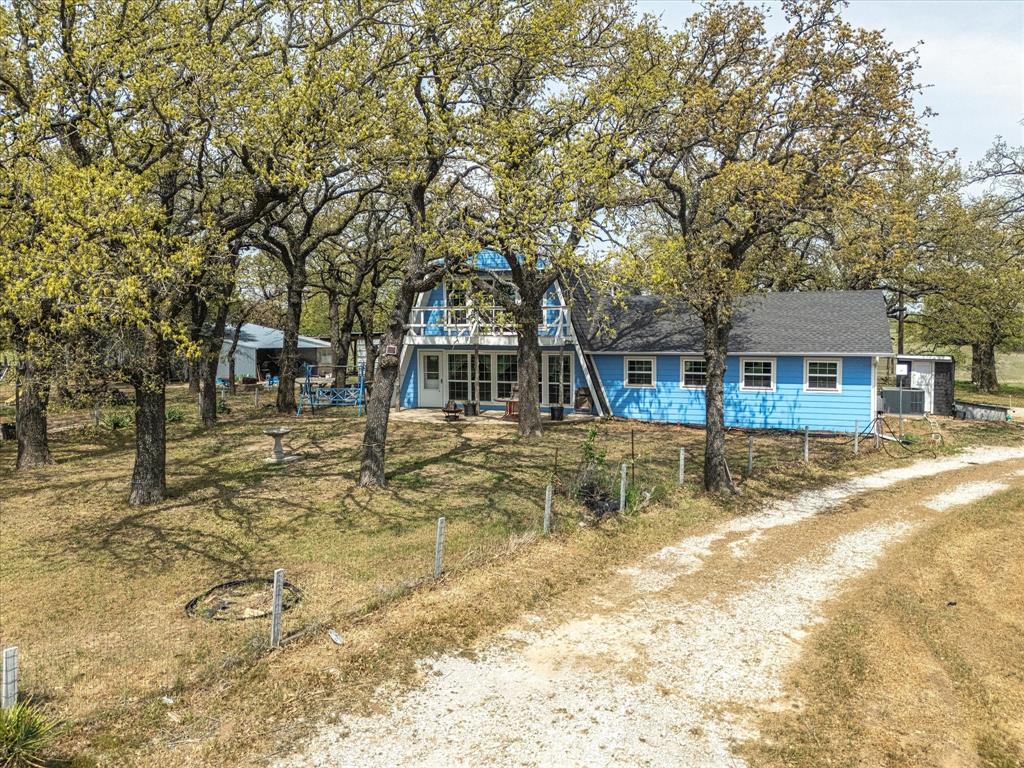 265 County Road 4374 Decatur, TX 76234 - Photo 7 of 32 a view of a house with large tree and a yard
