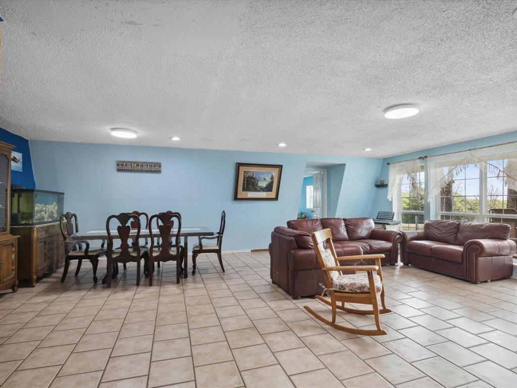 265 County Road 4374 Decatur, TX 76234 - Photo 10 of 32 a living room with furniture a dining table and a window