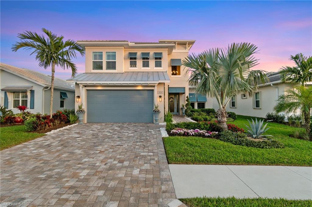a front view of a house with a yard and garage