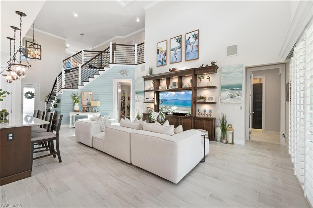 8936 Mustique Lane Naples, FL 34114 - Photo 11 of 29 a living room with furniture and a fireplace
