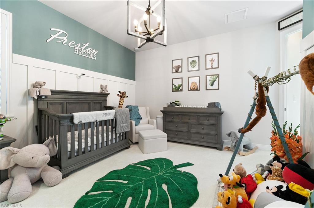8936 Mustique Lane Naples, FL 34114 - Photo 15 of 29 a bedroom with furniture and a baby crib