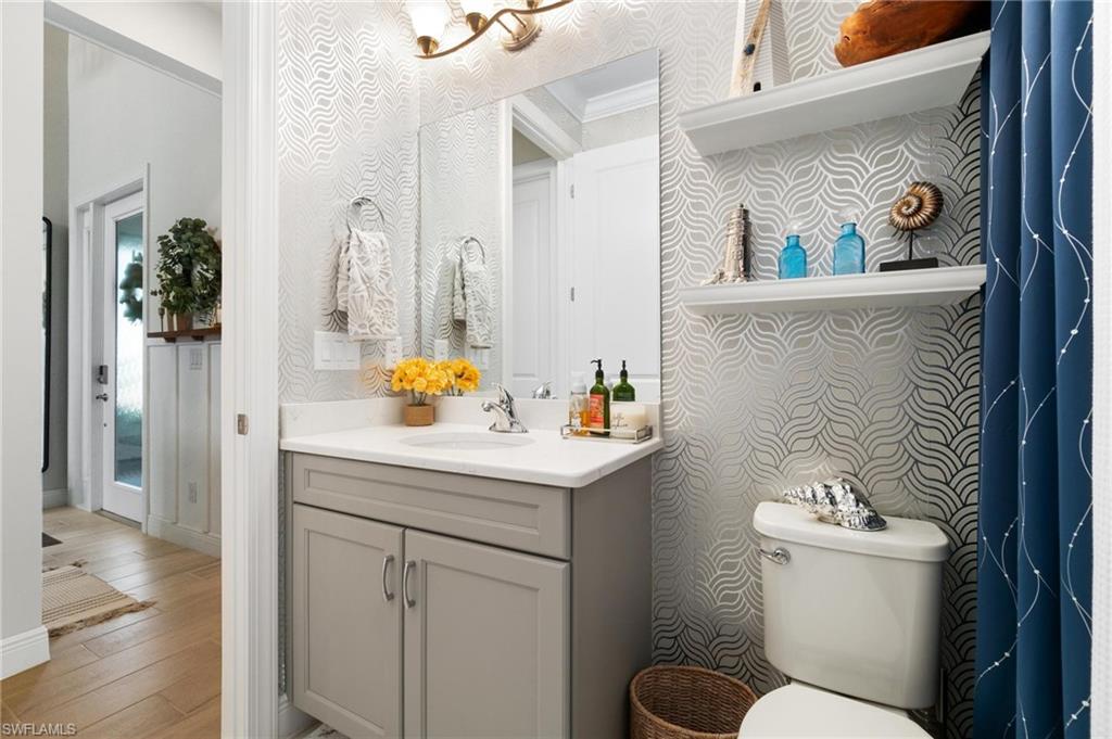 8936 Mustique Lane Naples, FL 34114 - Photo 16 of 29 a bathroom with a sink and a toilet