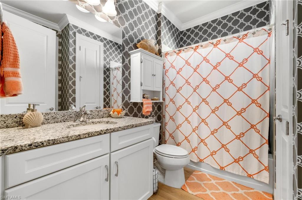 8936 Mustique Lane Naples, FL 34114 - Photo 18 of 29 a bathroom with a granite countertop sink and a mirror