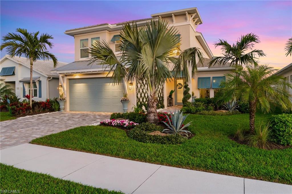 8936 Mustique Lane Naples, FL 34114 - Photo 2 of 29 a view of a house with a yard and potted plants