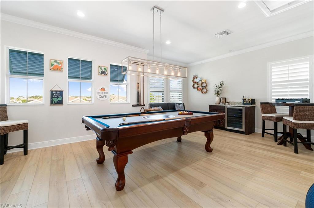 8936 Mustique Lane Naples, FL 34114 - Photo 21 of 29 a room with table chairs and windows