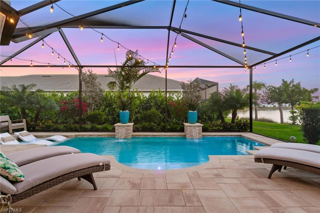 8936 Mustique Lane Naples, FL 34114 - Photo 23 of 29 a view of a swimming pool with a patio