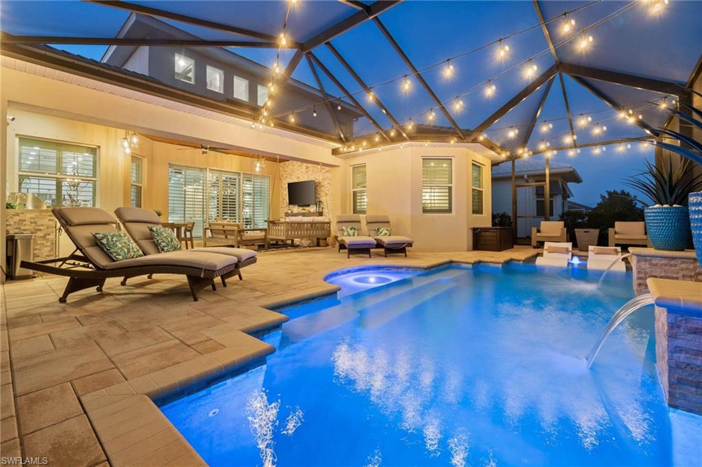 8936 Mustique Lane Naples, FL 34114 - Photo 26 of 29 a living room with lots of furniture and kitchen view