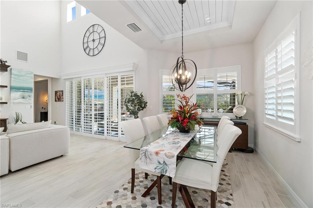 8936 Mustique Lane Naples, FL 34114 - Photo 9 of 29 a living room with furniture a table and a large window