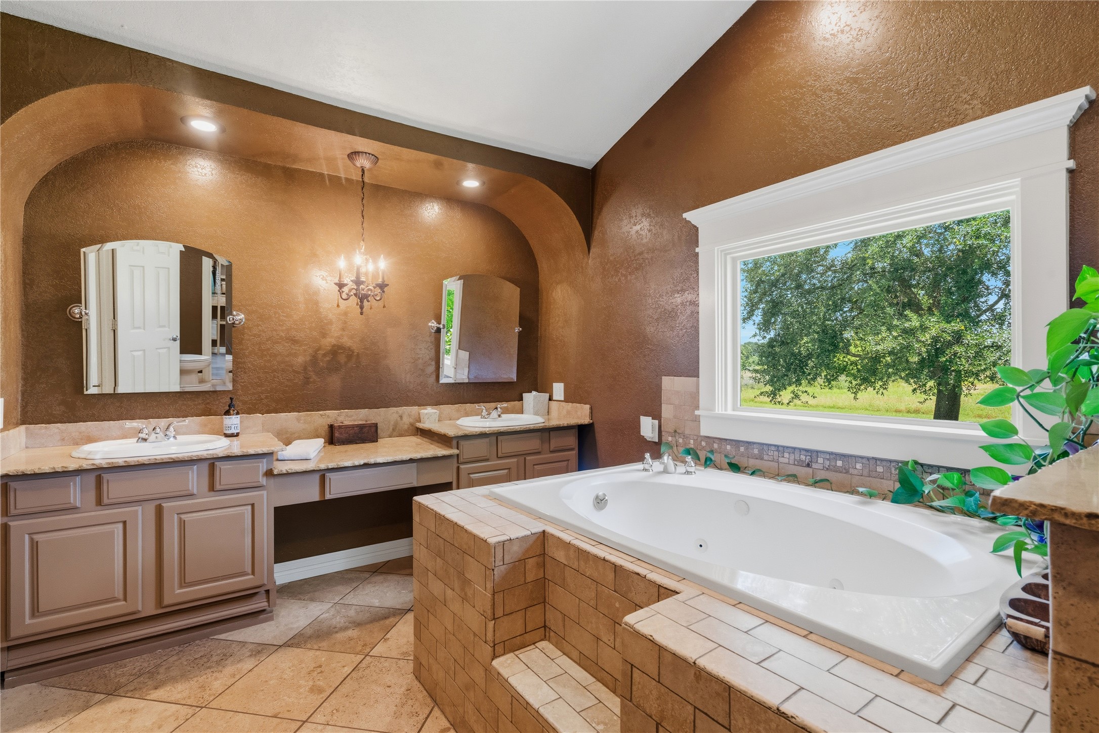 17821 Brown Road Conroe, TX 77306 - Photo 22 of 50 a spacious bathroom with a granite countertop sink and a large mirror