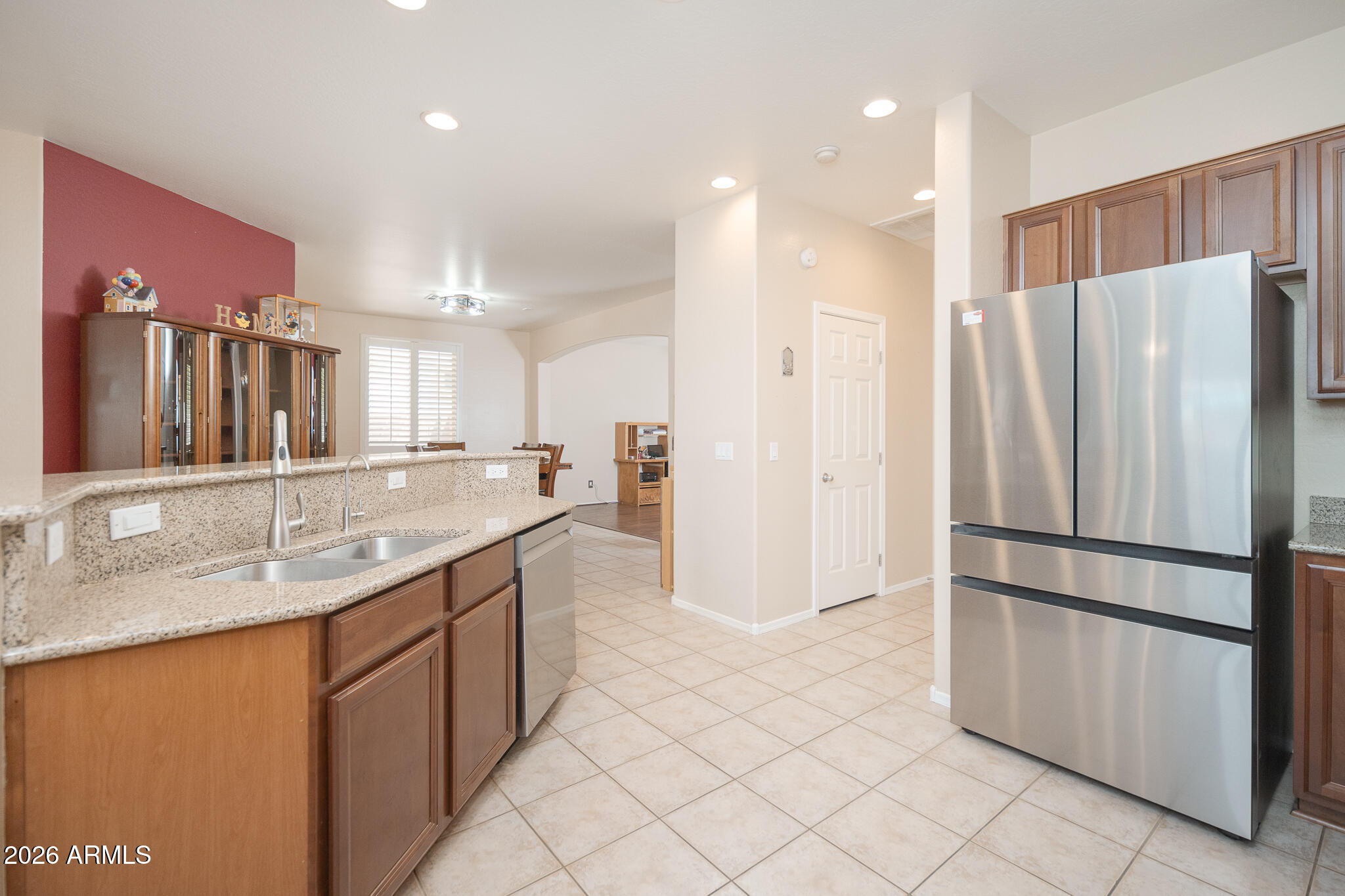 17284 West Madison Street Goodyear, AZ 85338 - Photo 11 of 34 a kitchen with stainless steel appliances granite countertop a refrigerator and a sink