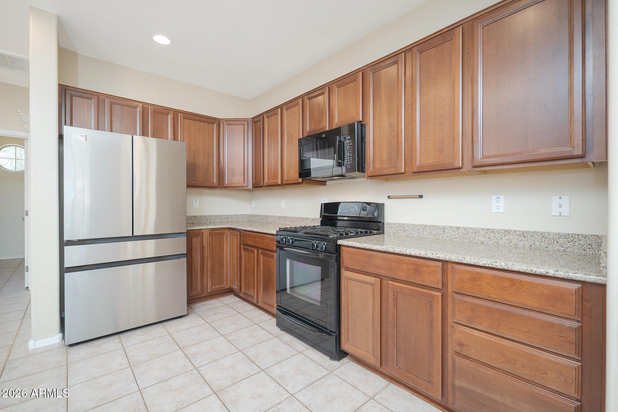 17284 West Madison Street Goodyear, AZ 85338 - Photo 12 of 34 a kitchen with stainless steel appliances granite countertop a refrigerator sink and cabinets