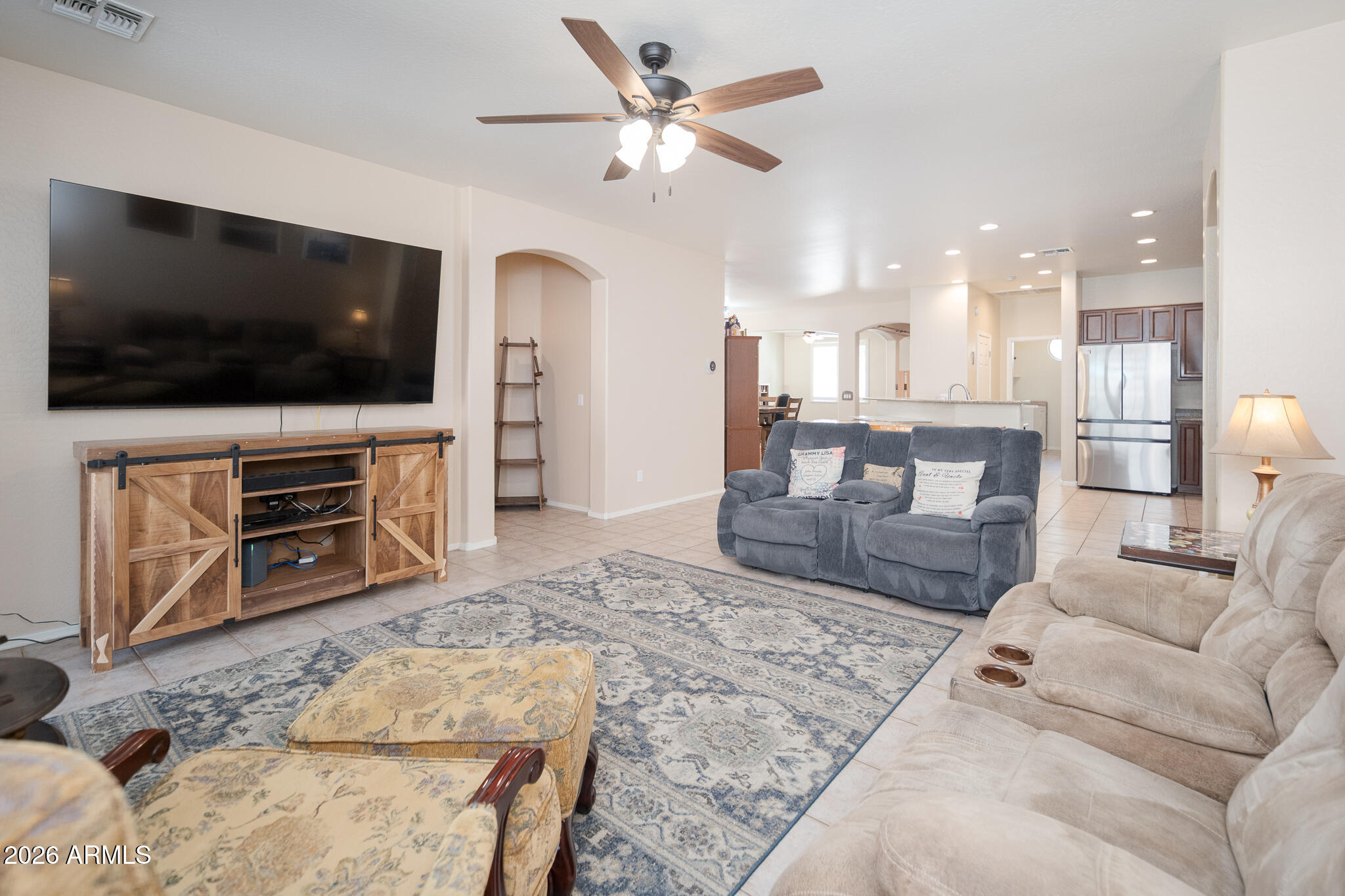 17284 West Madison Street Goodyear, AZ 85338 - Photo 14 of 34 a living room with furniture and a flat screen tv