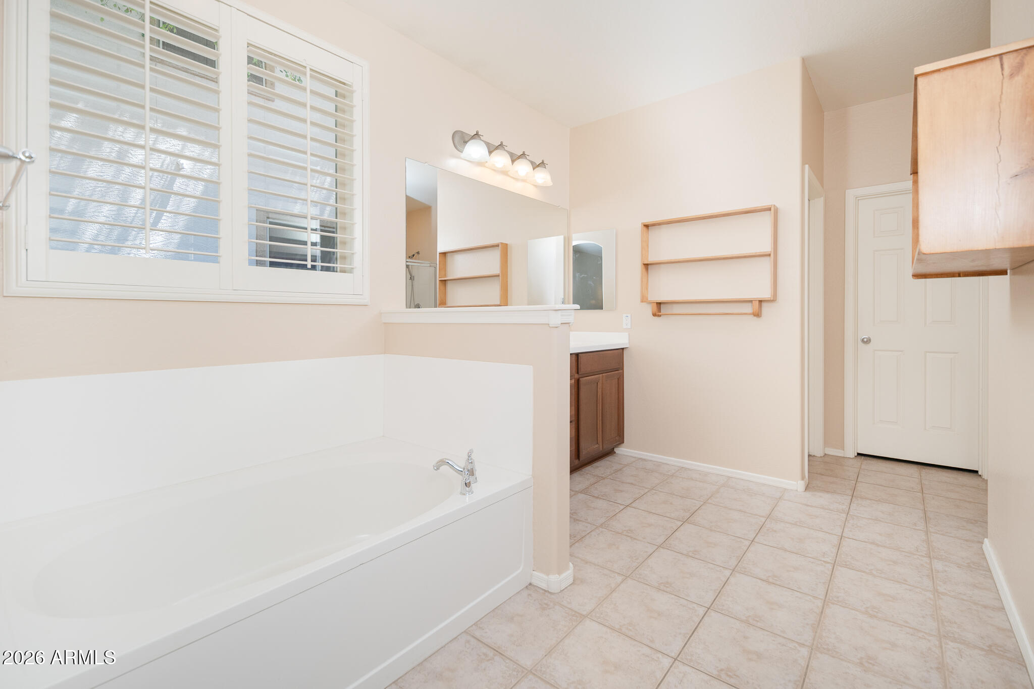 17284 West Madison Street Goodyear, AZ 85338 - Photo 17 of 34 a bathroom with a bathtub and a shower