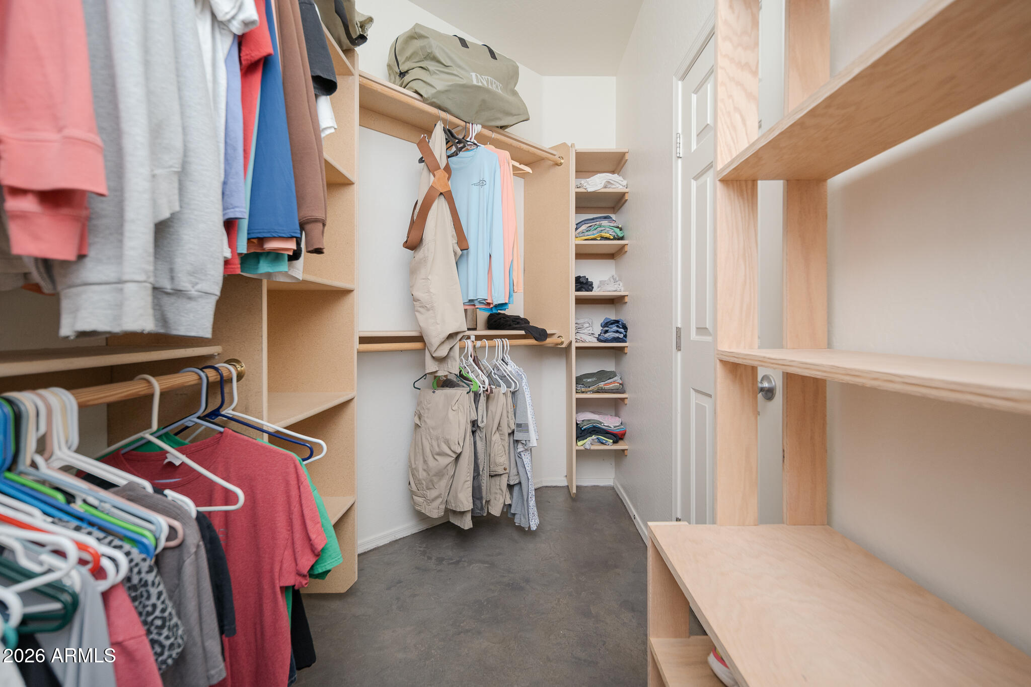 17284 West Madison Street Goodyear, AZ 85338 - Photo 20 of 34 a view of walk in closet with clothes and shoes