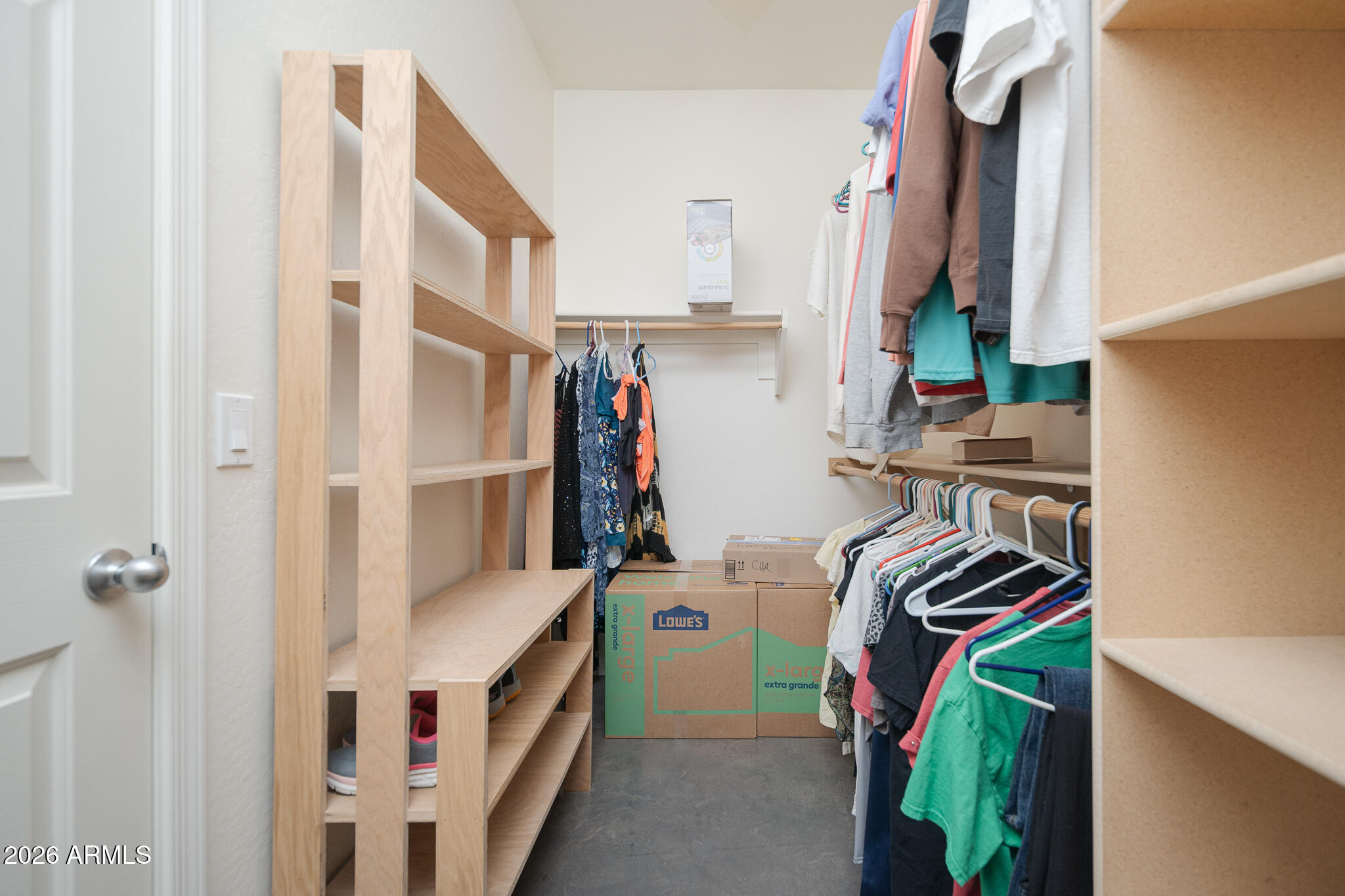 17284 West Madison Street Goodyear, AZ 85338 - Photo 21 of 34 a view of walk in closet with clothes and shoes