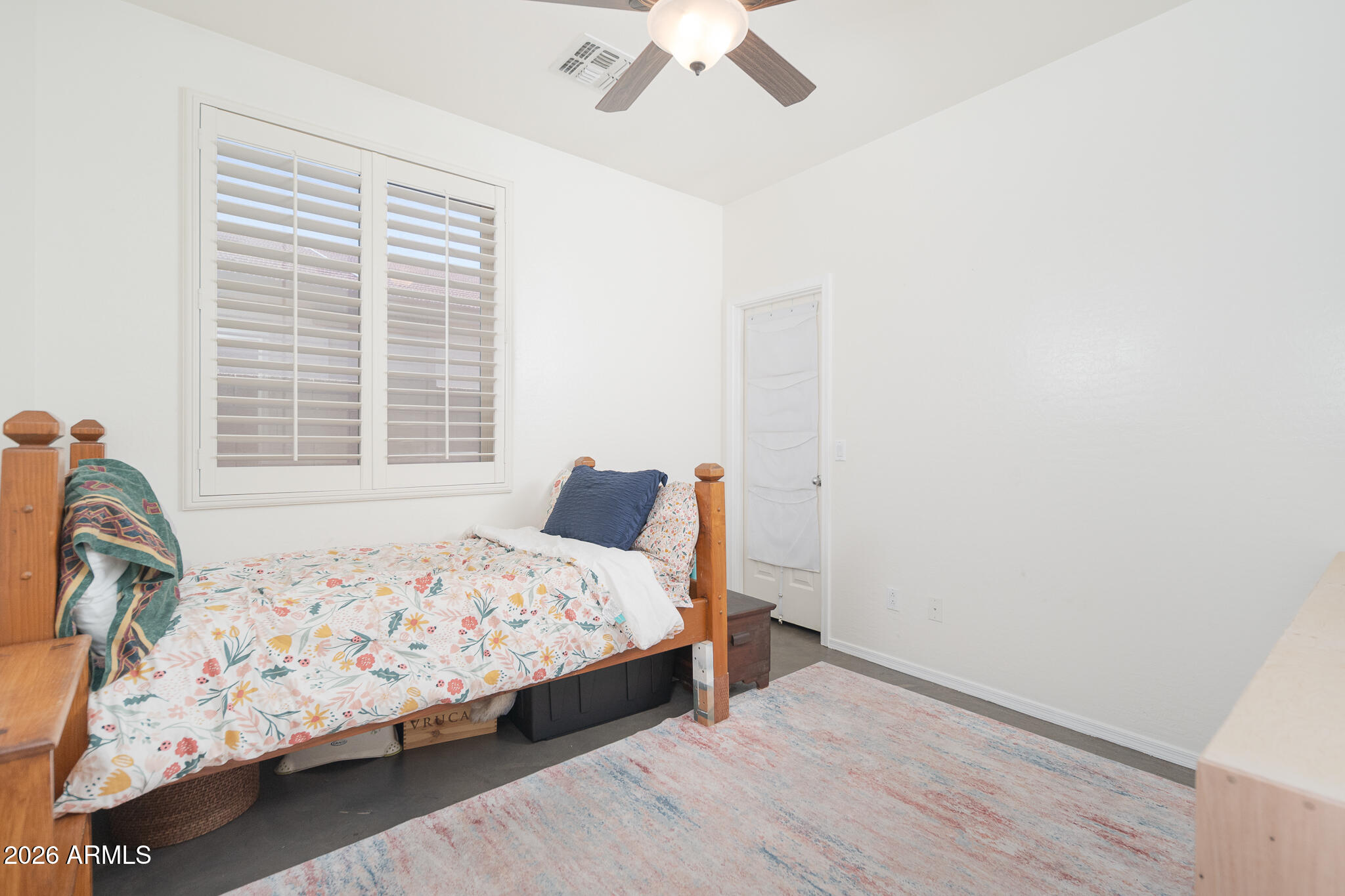 17284 West Madison Street Goodyear, AZ 85338 - Photo 22 of 34 a bedroom with a bed and window