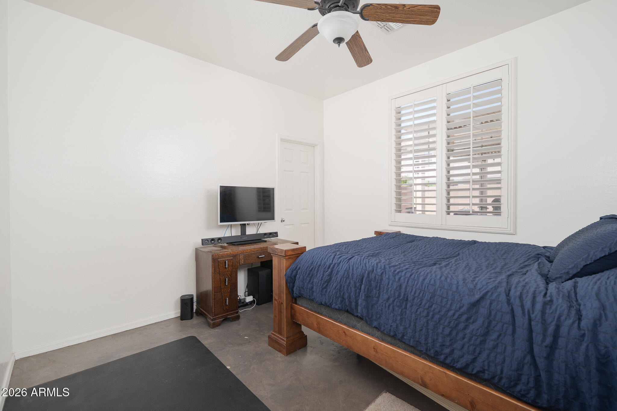 17284 West Madison Street Goodyear, AZ 85338 - Photo 24 of 34 a bedroom with a bed and a flat screen tv