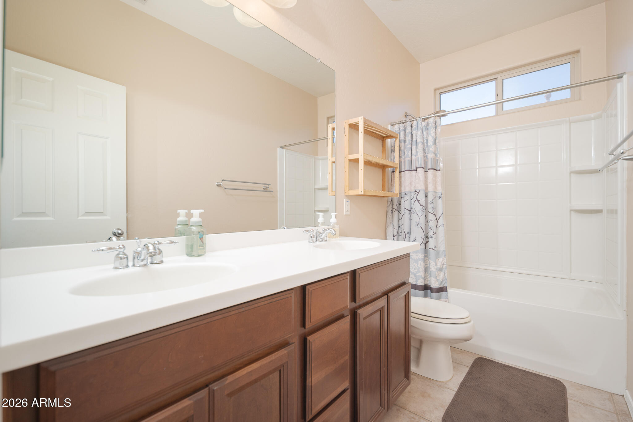 17284 West Madison Street Goodyear, AZ 85338 - Photo 25 of 34 a bathroom with a sink toilet a mirror and shower