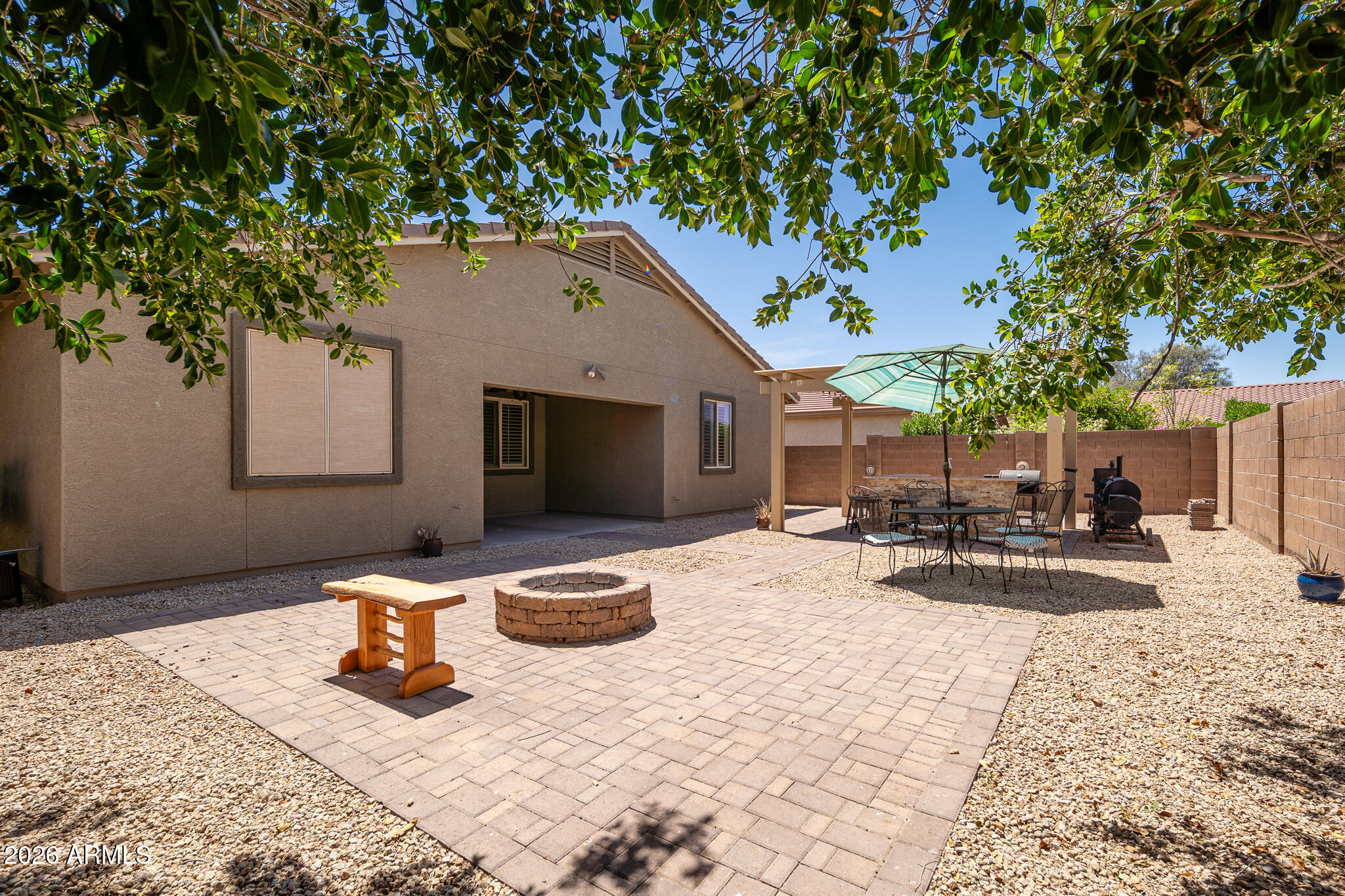 17284 West Madison Street Goodyear, AZ 85338 - Photo 28 of 34 a view of a lounge chair and tables in the patio
