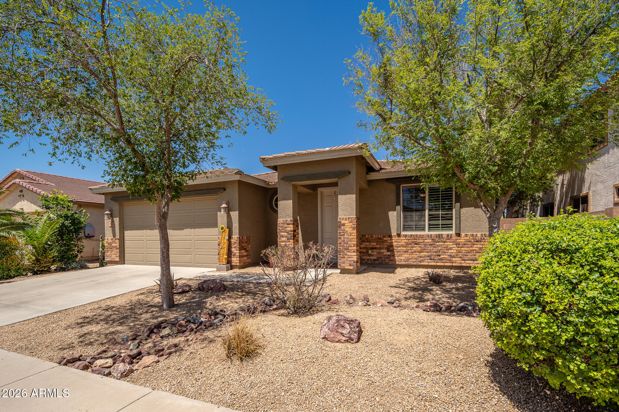 17284 West Madison Street Goodyear, AZ 85338 - Photo 2 of 34 front view of a house with a yard