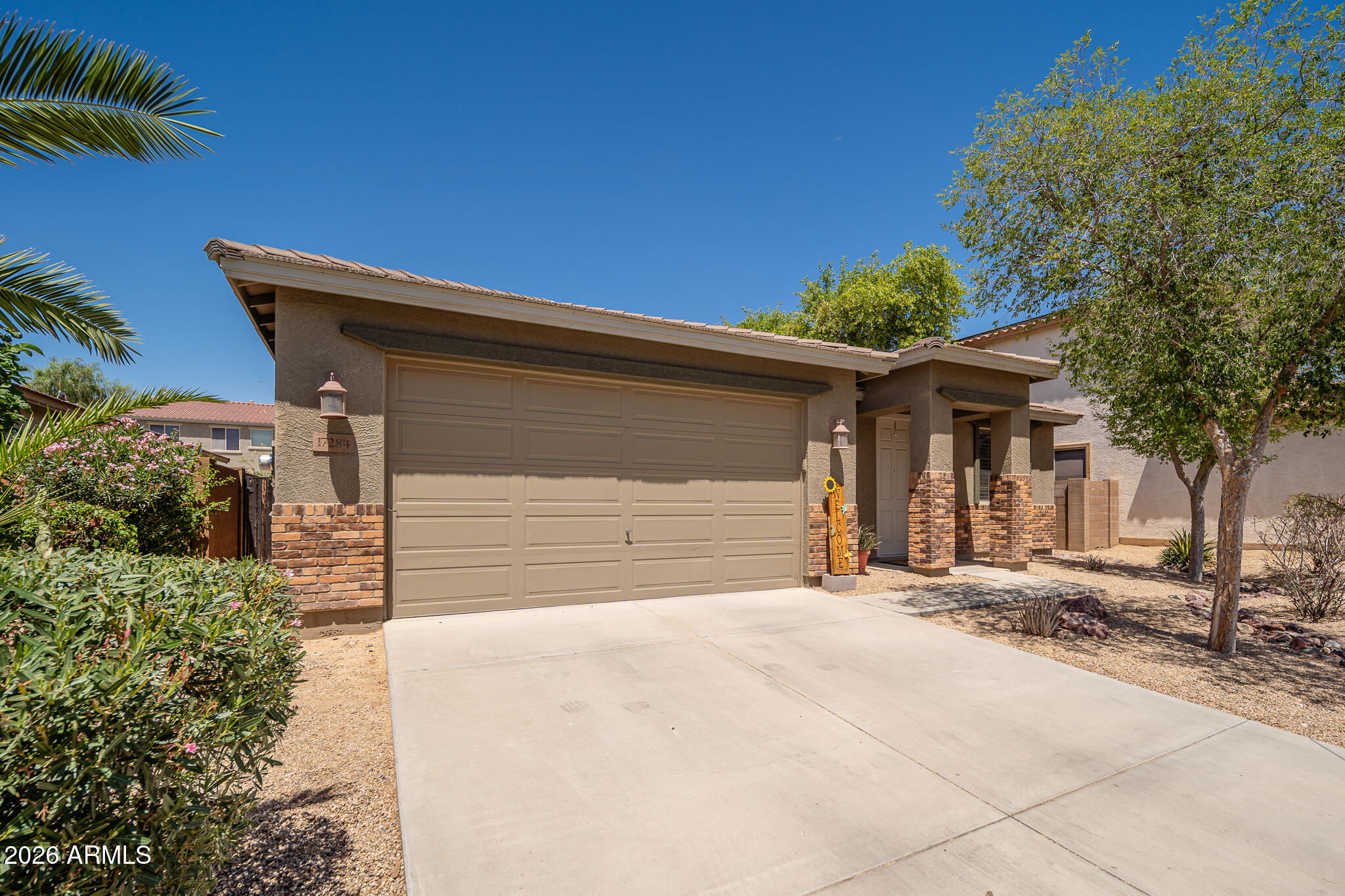 17284 West Madison Street Goodyear, AZ 85338 - Photo 3 of 34 a front view of a house with a outdoor space