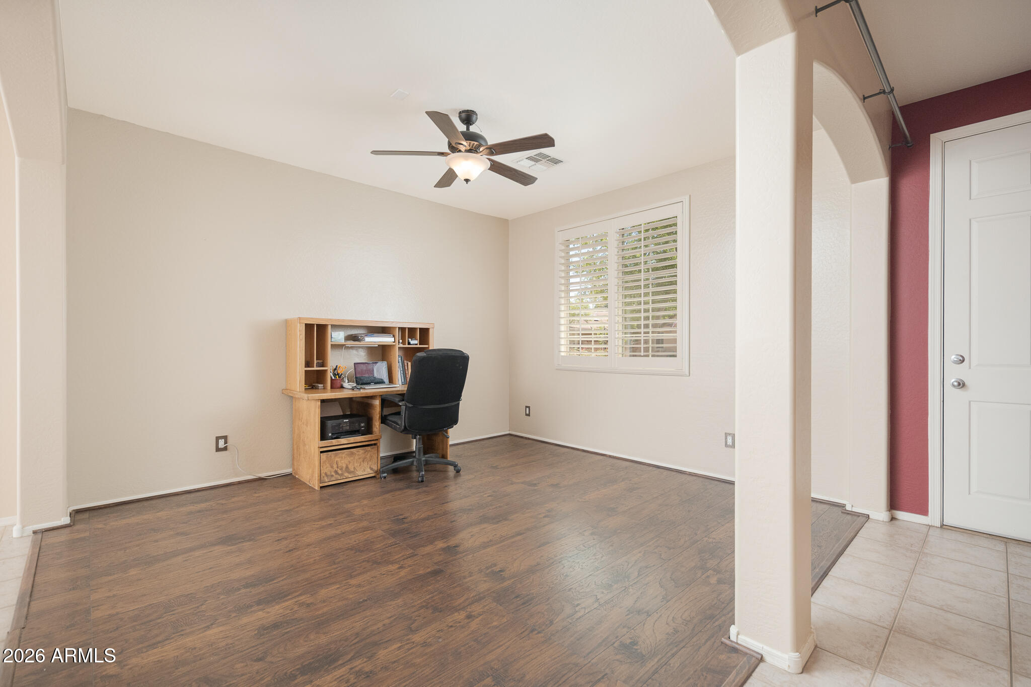 17284 West Madison Street Goodyear, AZ 85338 - Photo 7 of 34 a view of room with a window and wooden floor