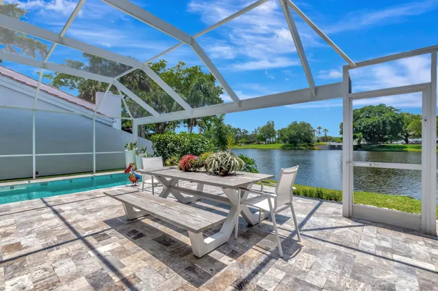 a front view of a house with a yard and potted plants