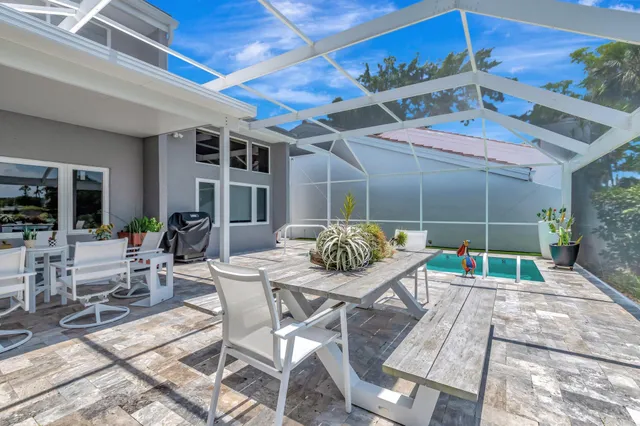 an aerial view of a house with a lake view and a large pool