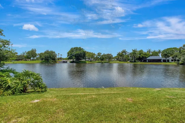 an aerial view of a house with a yard and lake view