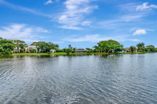 a living room with furniture a flat screen tv and a large window