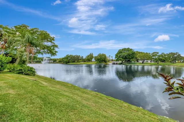 a kitchen with stainless steel appliances kitchen island granite countertop a large counter top and living room view
