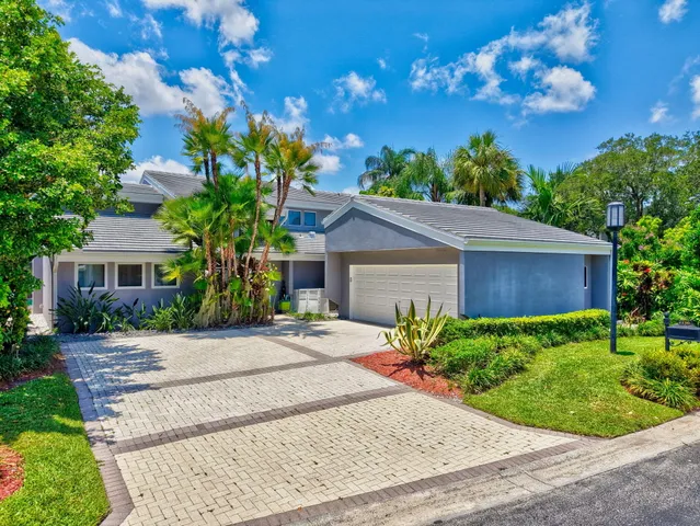 a large kitchen with kitchen island a large center island and stainless steel appliances