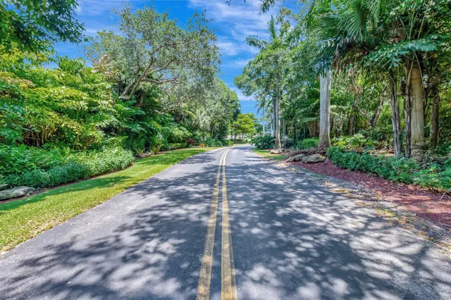 a view of a backyard with table and chairs under an umbrella