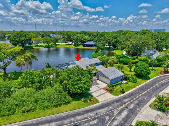 a living room with furniture a fireplace and chandelier