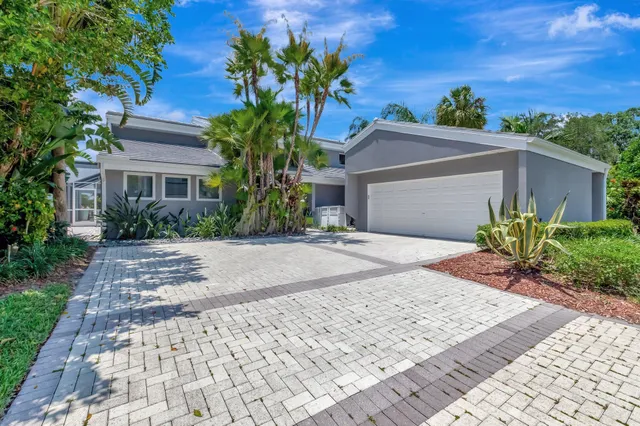 a view of a patio with a table and chairs under an umbrella