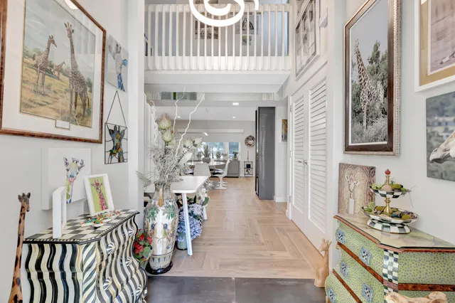 a kitchen with stainless steel appliances granite countertop a table chairs and a refrigerator