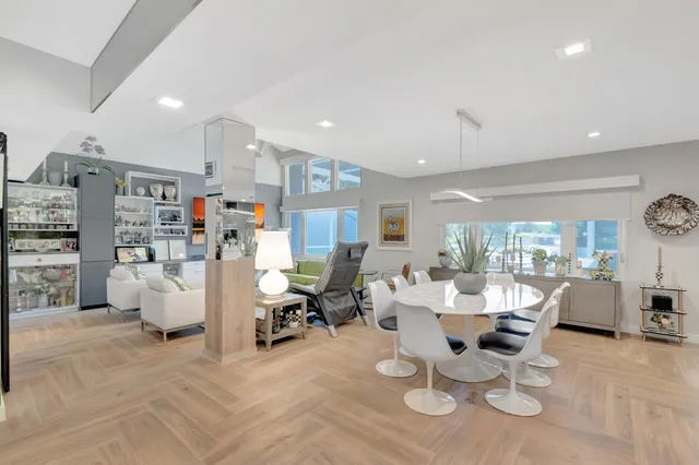 a living room with lots of furniture and a large window