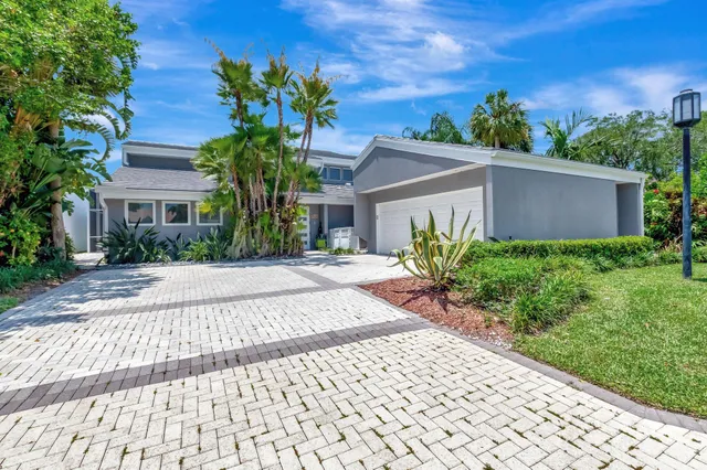 a view of a patio with table and chairs and potted plants
