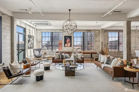 a living room with furniture and a chandelier