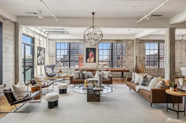 a living room with furniture and a chandelier