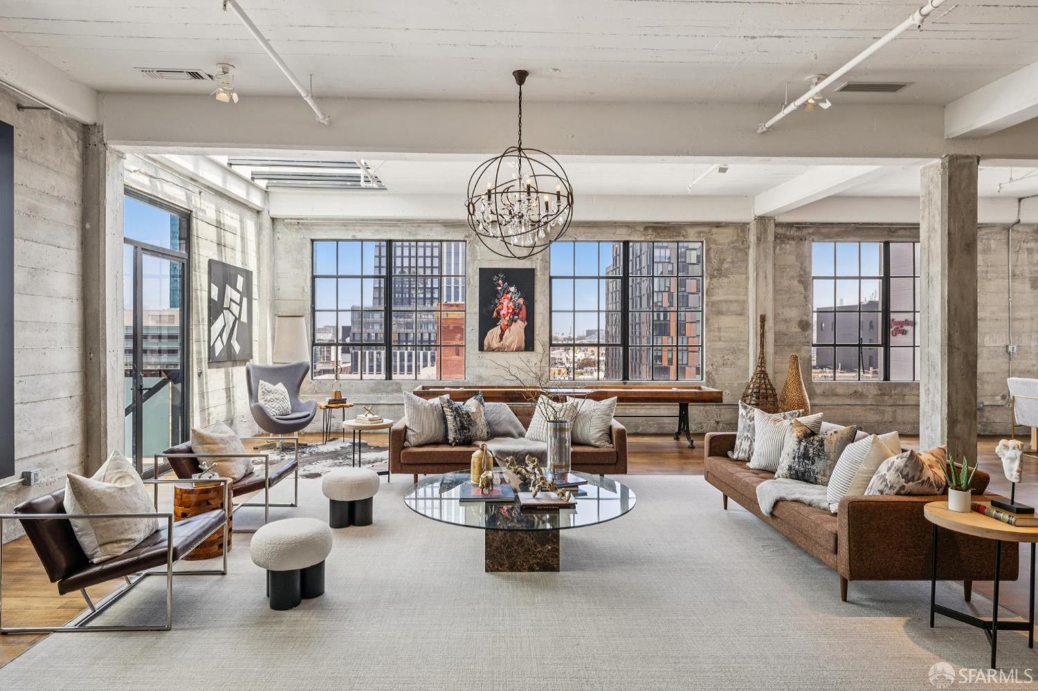 a living room with furniture and a chandelier