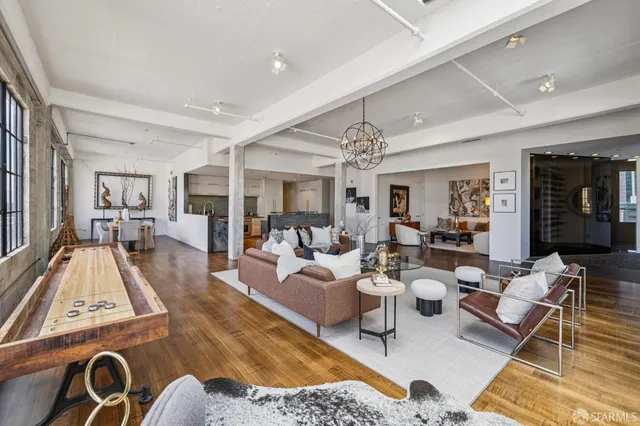 a living room with furniture and a chandelier
